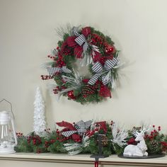 a mantel decorated with christmas wreaths and decorations