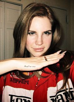 a woman with tattoos on her arm posing for the camera