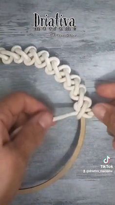 someone is making a ring out of yarn