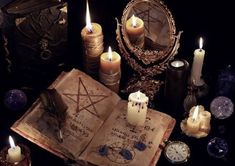 an open book surrounded by candles and other items with the words necheceros y alunagic