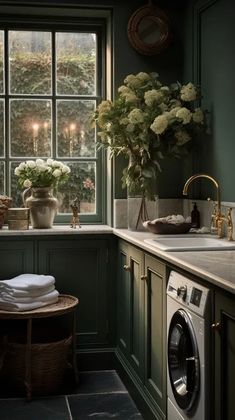 a washer and dryer in a green kitchen