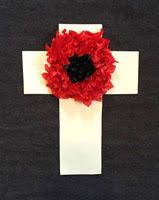 a cross decorated with red and black flowers on top of a white piece of paper