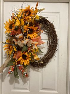 a sunflower wreath is hanging on the front door