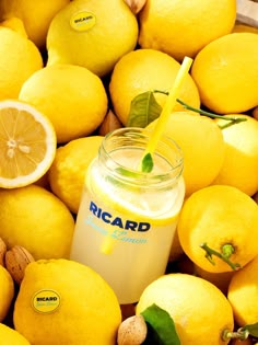 a jar of lemonade sitting on top of a pile of lemons