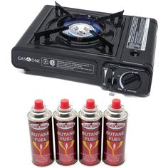 four cans of butane fuel next to a gas stove