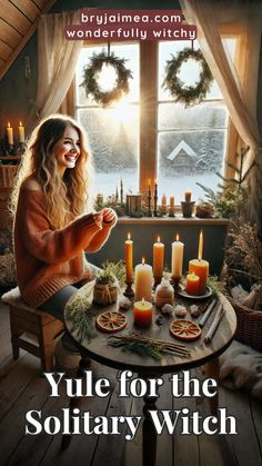 a woman sitting at a table with candles in front of her and the words yule for the solitary witch