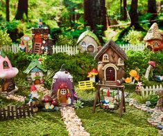 an assortment of fairy houses in the woods