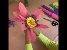 a child is making a paper flower out of construction material