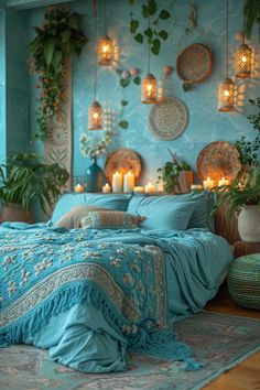 a bedroom decorated in blue and gold with candles on the wall, potted plants