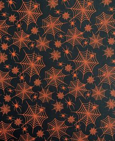 an orange and black background with spider webs on the bottom half of each pattern