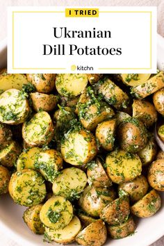 a white bowl filled with potatoes covered in herbs