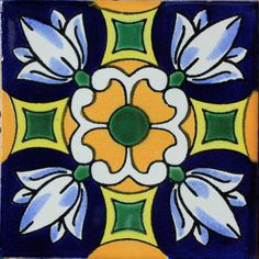 an artistic tile design in blue, yellow and green with white flowers on the center