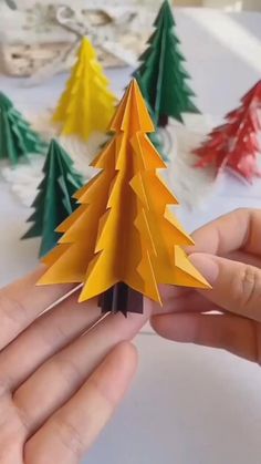 someone is making a christmas tree out of paper