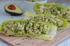 lettuce wraps filled with chicken and avocado on a cutting board