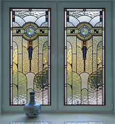 two stained glass windows with blue and white vase in the foreground on a tiled floor