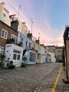 a cobblestone street lined with tall buildings