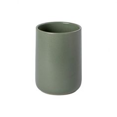 a green cup sitting on top of a white table