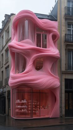 a pink building that looks like it's blowing in the wind