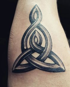 a tattoo on the leg of a person with a celtic knot in it's center