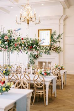 an elegant dining room set up with flowers and candles