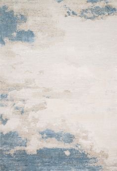 a blue and white rug with clouds on it