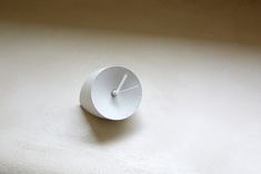 a white clock sitting on top of a wall