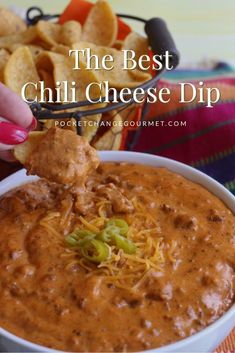 the best chili cheese dip is in a bowl with tortilla chips