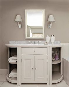 a bathroom with a sink, mirror and bathtub in the middle of the room