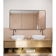 two white sinks sitting under a large mirror in a bathroom next to a wooden counter