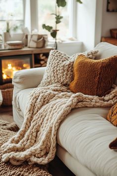 a white couch with blankets and pillows on it