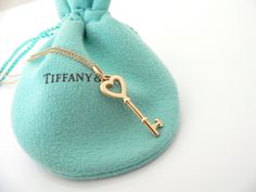 Overview:Time to show off your awesome Tiffany necklace! Offered for sale is a classic and very pretty Tiffany and Co. 18K Gold Heart Key Charm Necklace. Wonderful necklace that fits a lifestyle on the go -- the necklace can be worn to almost any occasion! Hanging from its beautiful Tiffany & Co. 18K Gold curb chain is a super pretty 18K Heart Key charm. It is simple and yet looks extremely elegant. Imagine the piece with your professional office attire ... Now imagine it with jeans or weeke Tiffany Blue Key Necklace, Luxury Locket Necklace For Valentine's Day, Key Charm Necklace, Tiffany Necklace, Heart And Key, Key Necklace, Tiffany And Co, Heart Of Gold, Tiffany & Co.