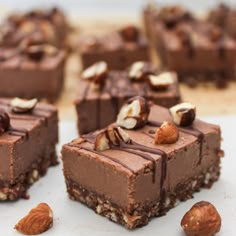 several pieces of chocolate dessert with nuts on top