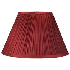 a red lamp shade with pleated fabric on the bottom and bottom, is shown