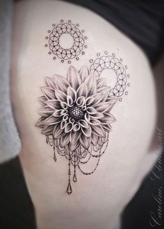 a woman's stomach with a flower tattoo on it