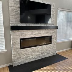 a fireplace with a flat screen tv mounted above it