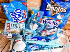 a basket filled with candy and snacks on top of a wooden table