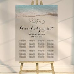 an easel with a wedding seating chart on it in front of a white wall