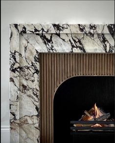 a fire place with a marble fireplace surround