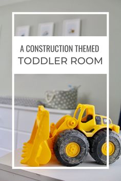 a construction themed toddler room with toys on the table and in front of it