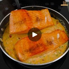 two salmons are being cooked in a skillet