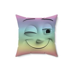 a pillow with a smiling face on the front and back side, in pastel colors