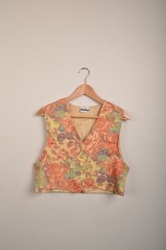 "vintage 90s flower spencer in great vintage condition. Size: 42 (see measurements) Measurements: - Chest(armpit to armpit: 47m(18.5\") - Length from the backside(Center bottom of the collar to center bottom of the garment): 42cm(16.5\") - Shoulder to shoulder: 34cm(13.3\") NOTE: Due to the age, clothing/items can shrink or it may be that the sizing from that time the item was made in, is not the same as the sizing in modern clothing and current sizes. Make sure you check our measurements first Retro V-neck Vest For Spring, Vintage V-neck Vest For Spring, Bohemian Floral Print Spring Vest, Spring Floral Print V-neck Vest, Retro Sleeveless Spring Vest, Retro V-neck Spring Vest, Spring V-neck Retro Vest, 90s Style Vest Top For Spring, 90s Style Spring Vest