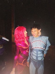 two people dressed up in costumes standing next to each other