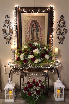 the altar is decorated with flowers, candles and an image of jesus on it's wall