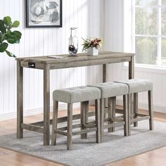 a wooden table with three stools in front of it