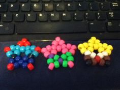 three different colored candies sitting on top of a computer keyboard