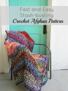 a crocheted afghan sitting on top of a metal chair next to a blue door