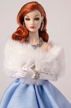 a doll wearing a blue dress and white fur stole