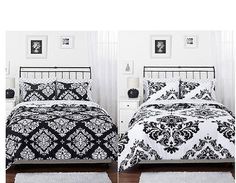 two beds with black and white comforters in a room