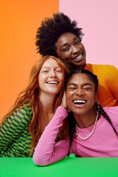 three women are posing for the camera with their arms around each other, smiling and laughing